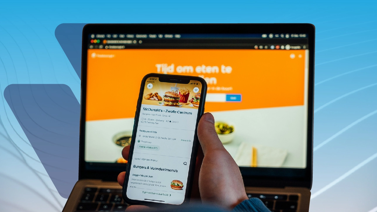 Customer using a mobile restaurant menu with responsive website on laptop screen — web design for restaurant in action.