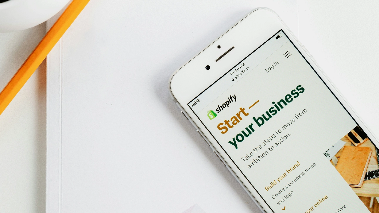 Smartphone displaying Shopify’s ‘Start your business’ page with options to build a brand and create an online store.